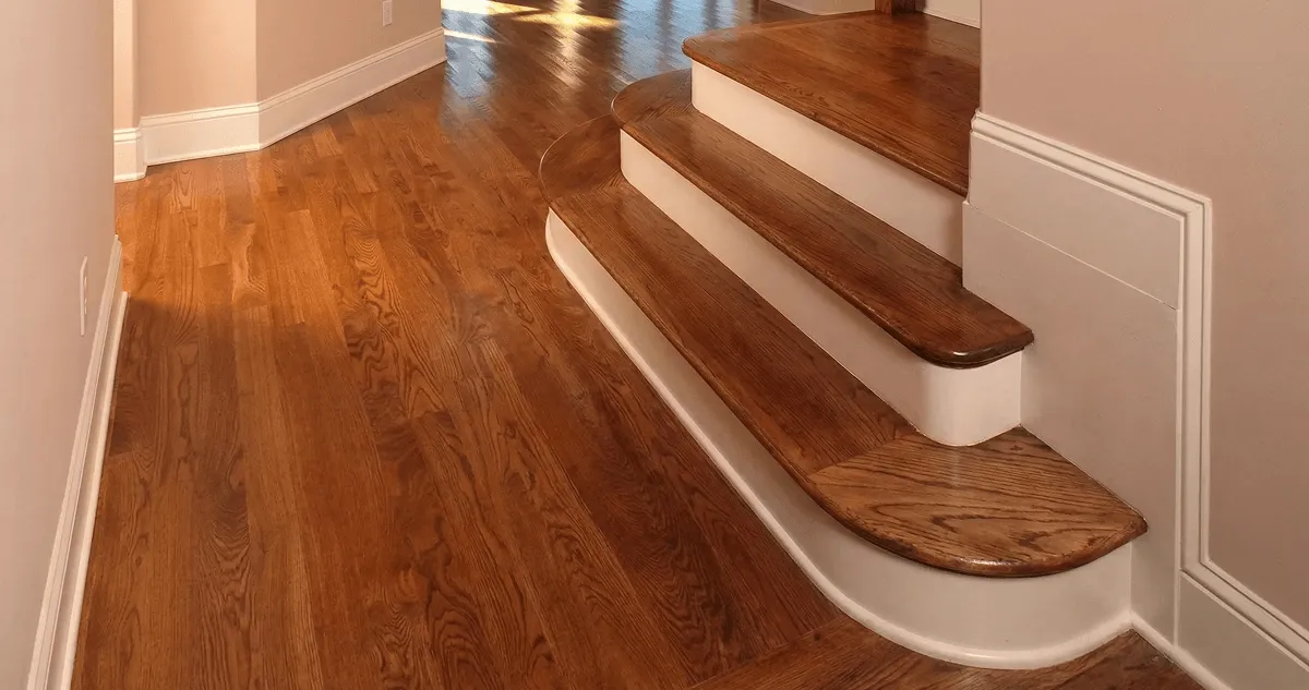 Base floor of a staircase with professionally restored wood flooring in Chicago IL