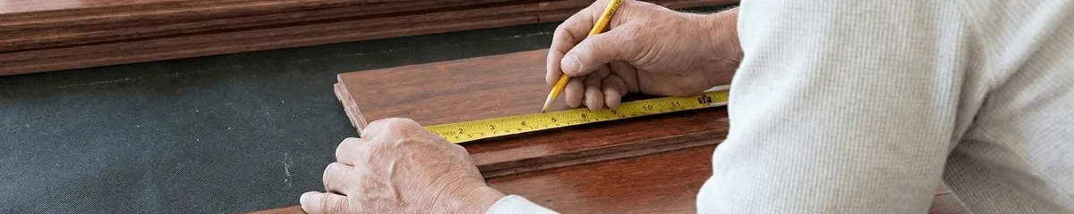 A professional installing wood flooring in Chicago, IL